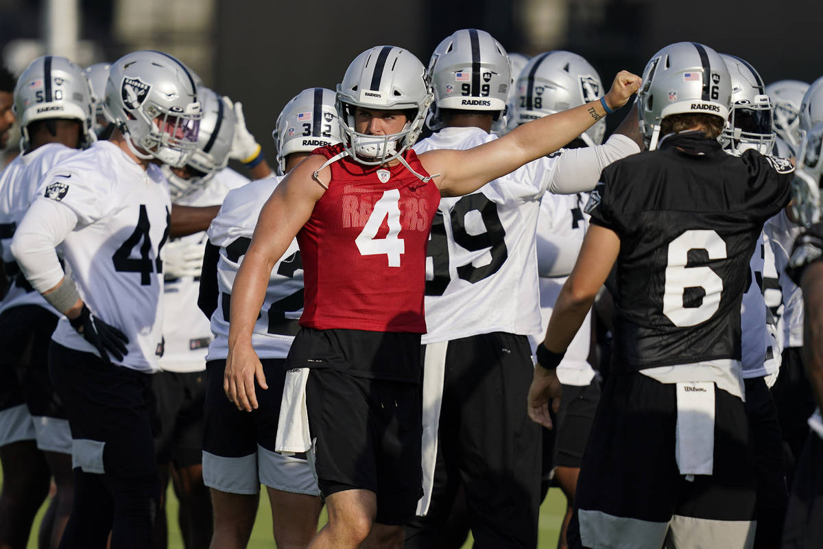 Las Vegas Raiders quarterback Derek Carr (4) huddles with teammates during an NFL football trai ...