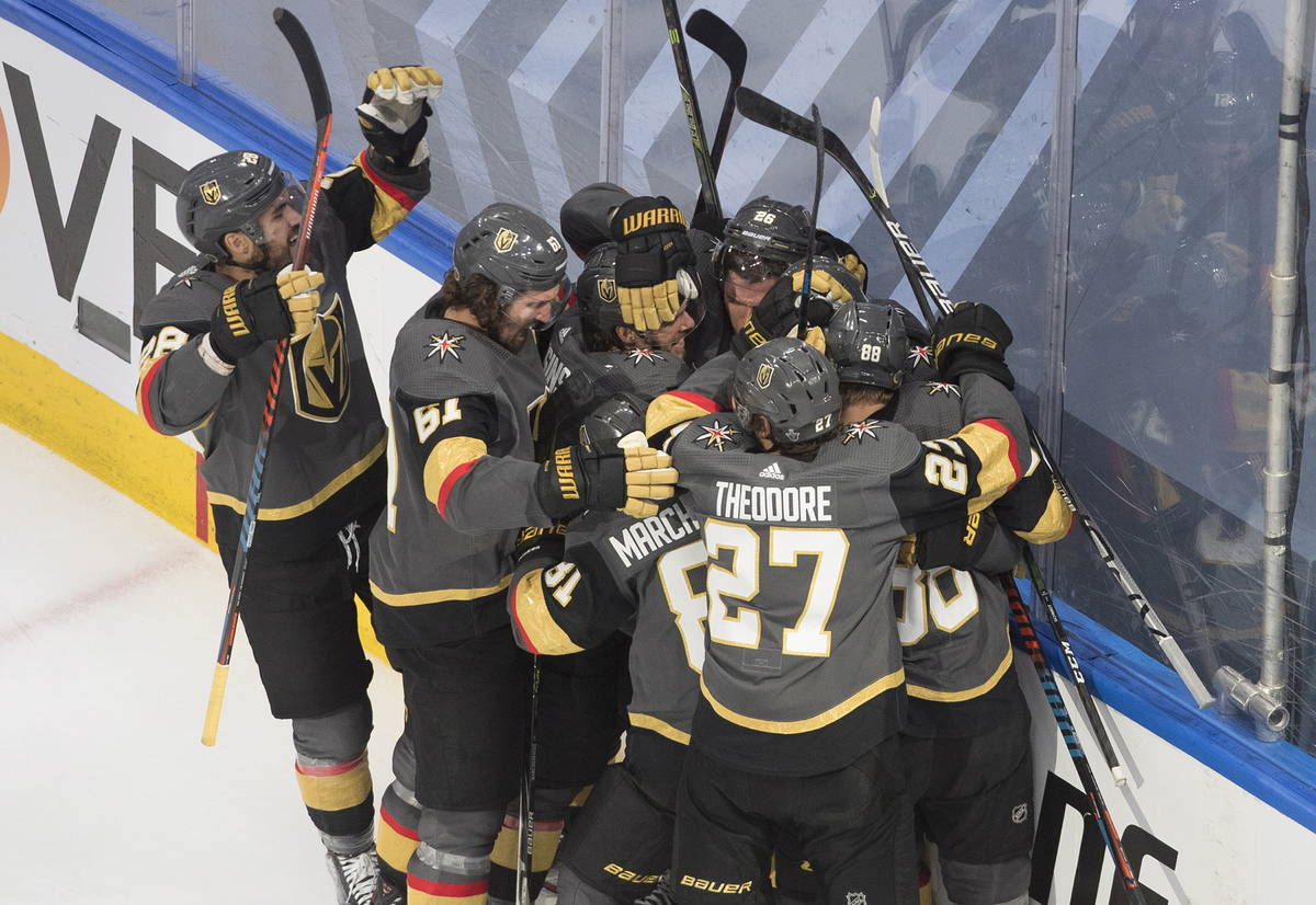 Vegas Golden Knights players celebrate their win over the Chicago Blackhawks after an NHL hocke ...