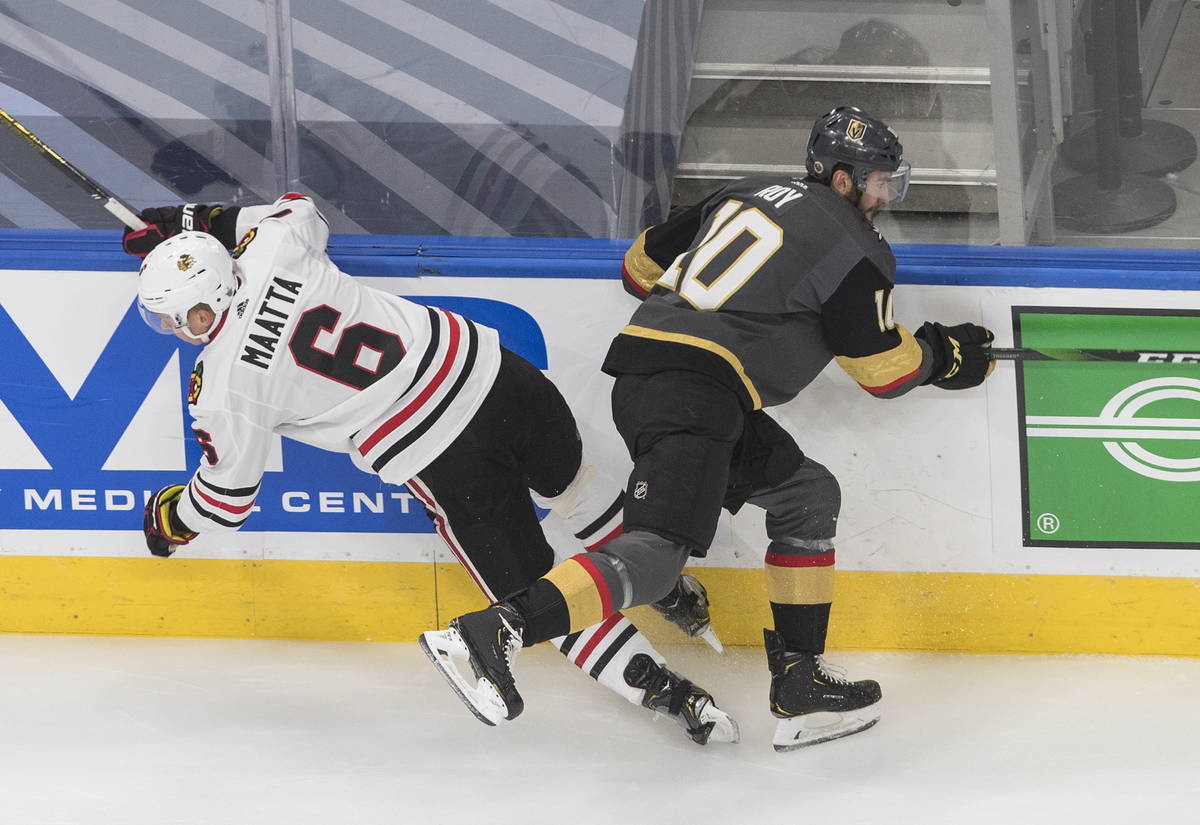 Vegas Golden Knights' Nicolas Roy (10) checks Chicago Blackhawks' Olli Maatta (6) during the fi ...