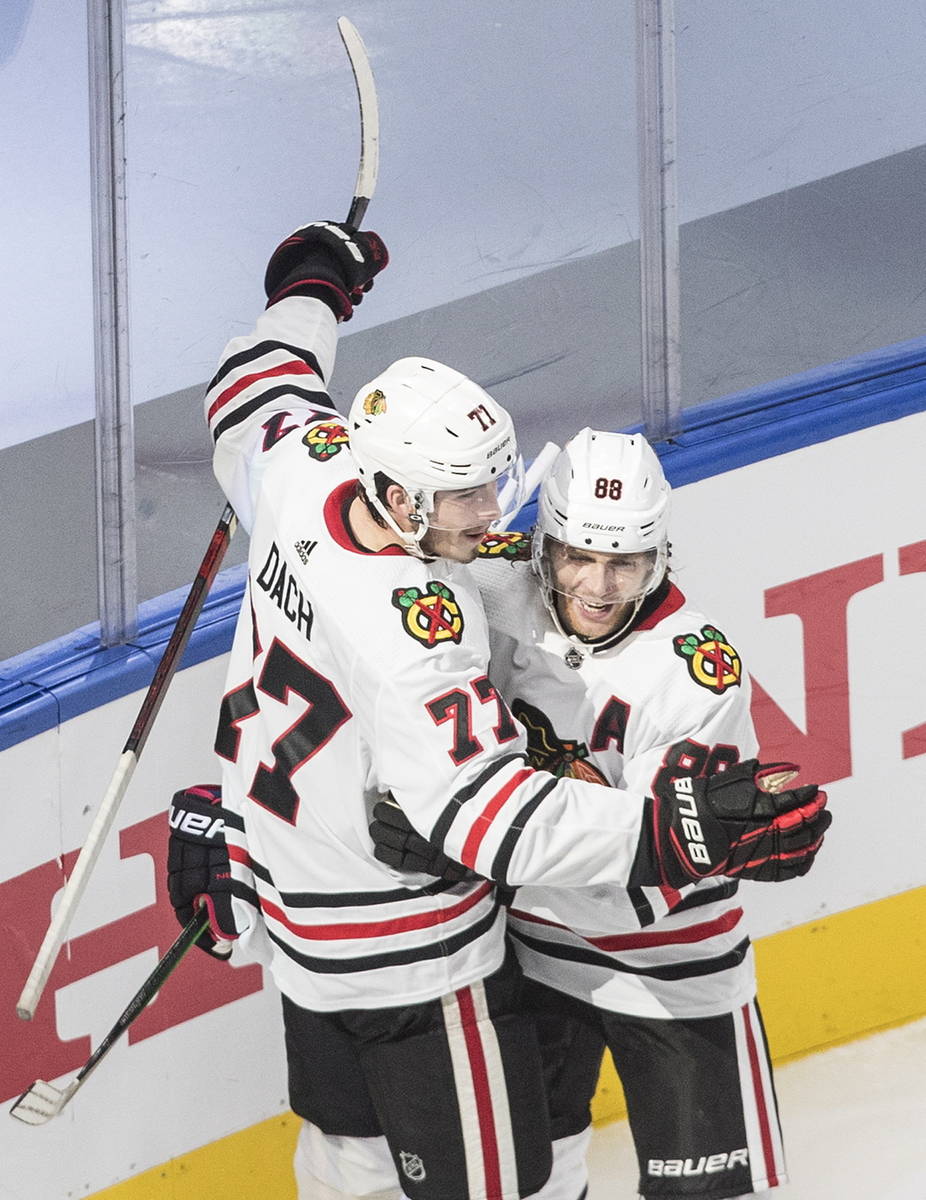 Chicago Blackhawks' Kirby Dach (77) and Patrick Kane (88) celebrate a goal against the Vegas Go ...