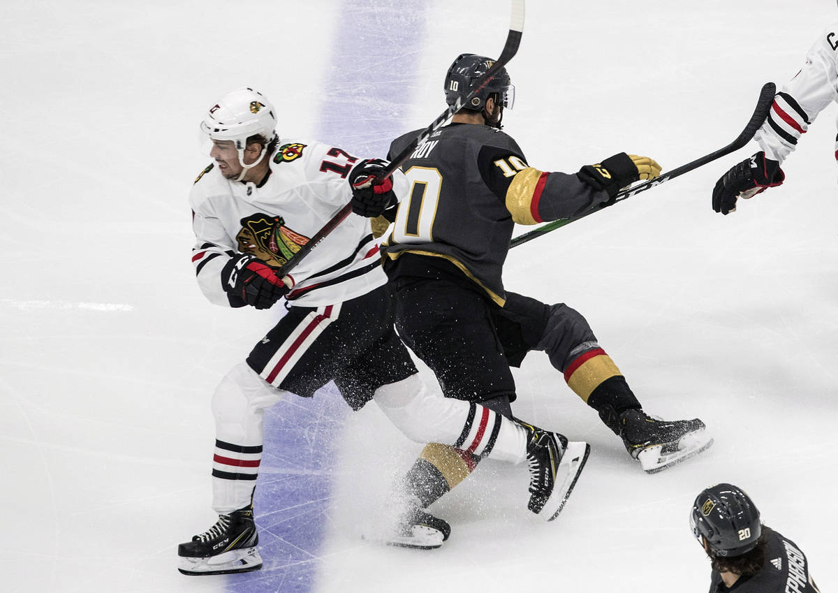 Vegas Golden Knights' Nicolas Roy (10) and Chicago Blackhawks' Dylan Strome (17) collide during ...