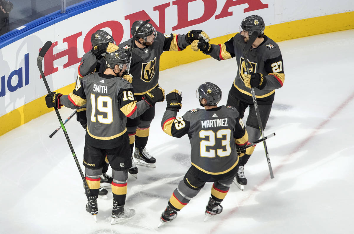 Vegas Golden Knights players celebrate a goal against the Chicago Blackhawks during the first p ...