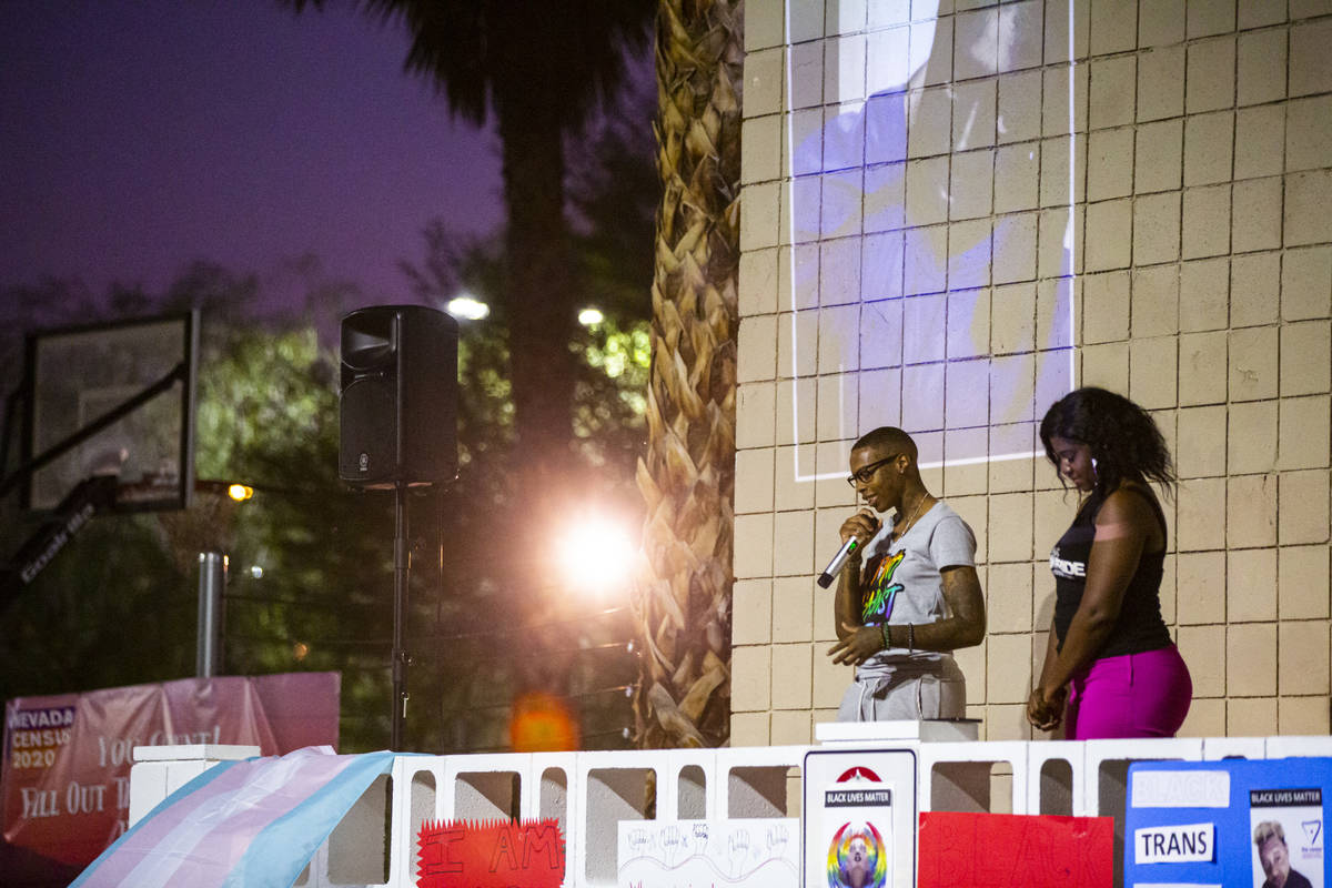 Johanna "King" Perez, left, leads a prayer during a candlelight vigil, in remembrance of the bl ...