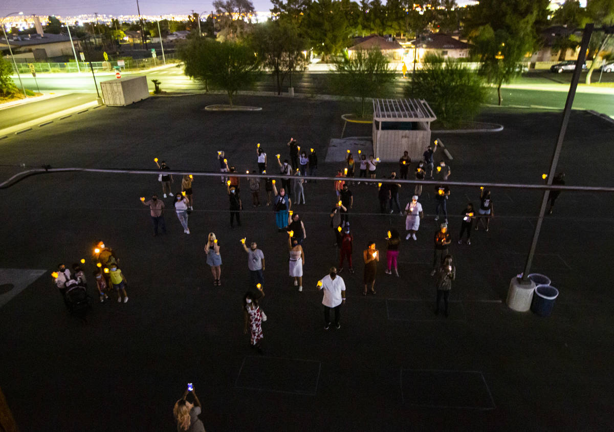 People gather to form the transgender symbol during a candlelight vigil, in remembrance of the ...