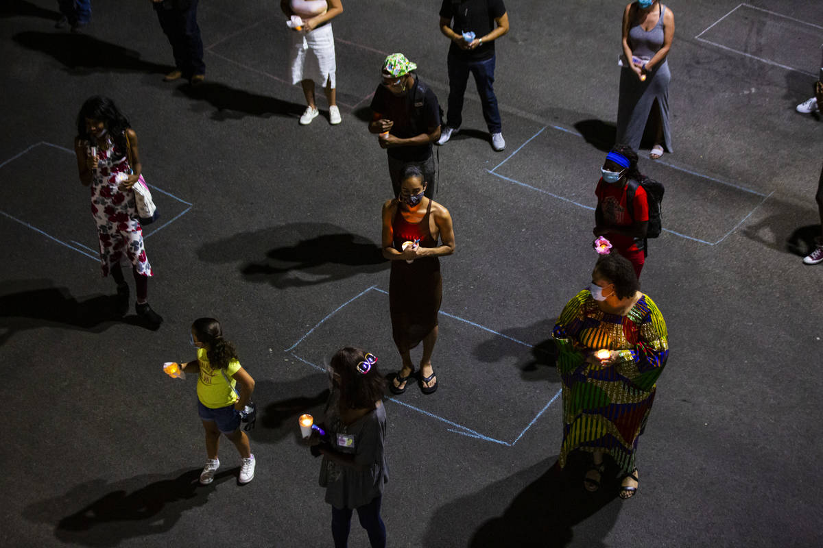 People gather in the shape of the trans symbol during a candlelight vigil, in remembrance of th ...
