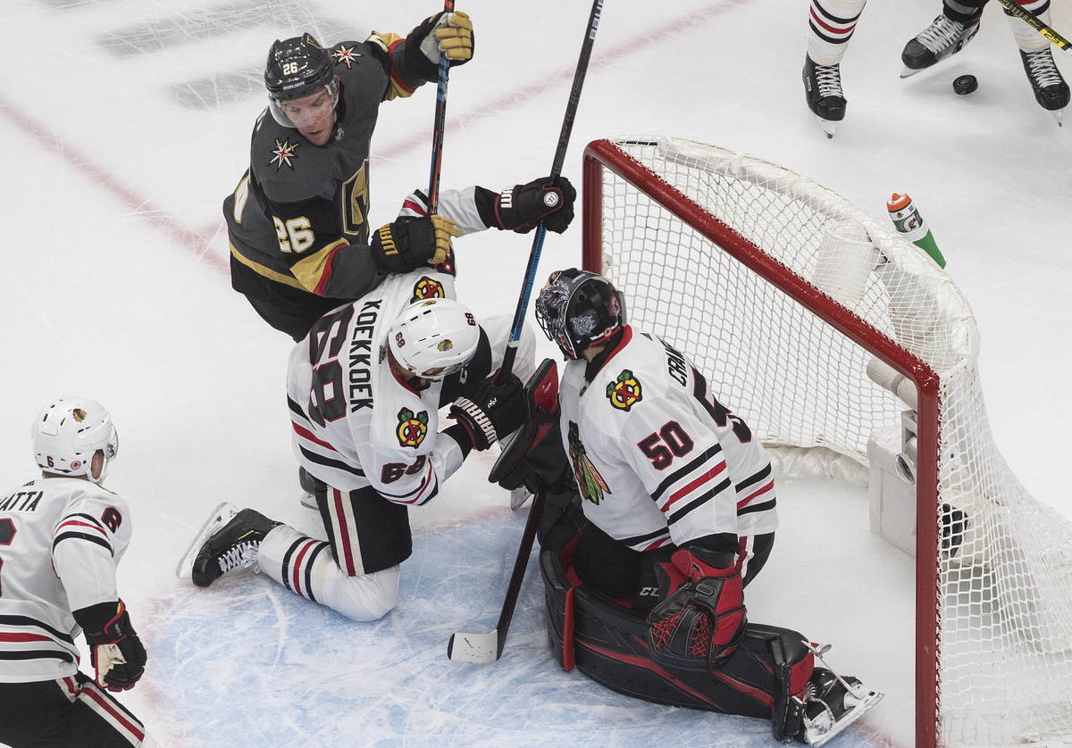 Vegas Golden Knights' Paul Stastny (26) and Chicago Blackhawks' Slater Koekkoek (68) battle in ...