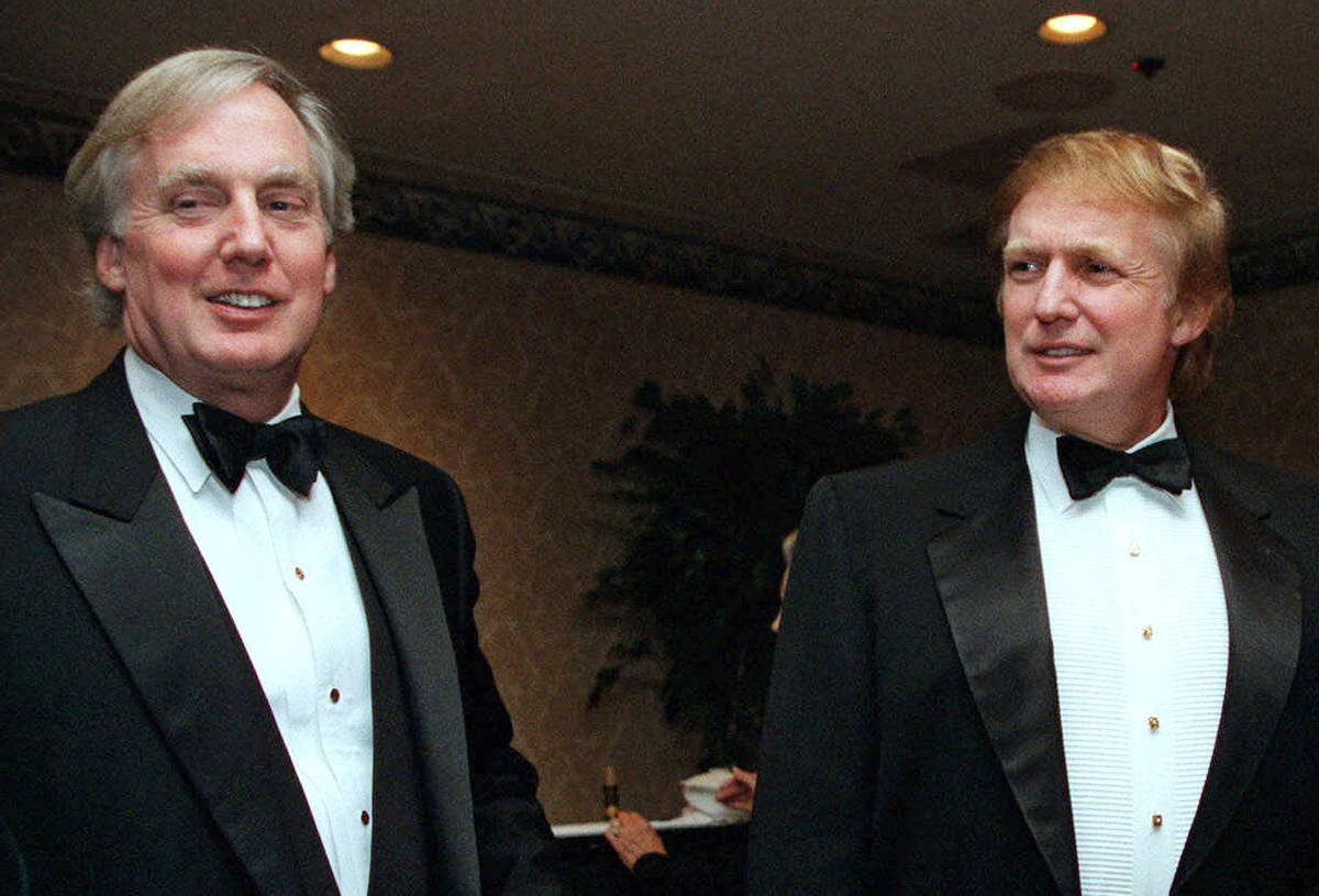 In this Nov. 3, 1999 file photo, Robert Trump, left, joins then real estate developer and presi ...