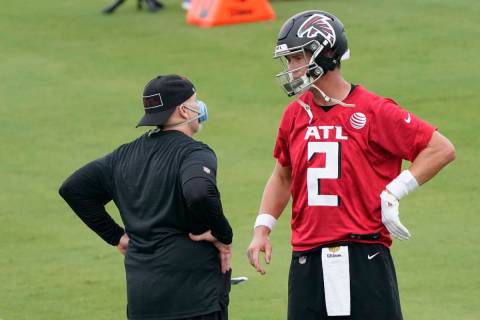 Atlanta Falcons head coach Dan Quinn talks with quarterback Matt Ryan during an NFL football tr ...