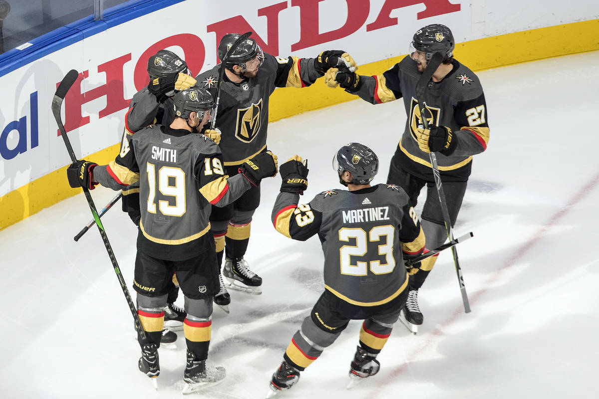 Vegas Golden Knights players celebrate a goal against the Chicago Blackhawks during the first p ...