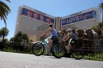 People ride their bikes at the Strip near The Mirage on the Las Vegas Strip, May 23, 2020. (Eri ...