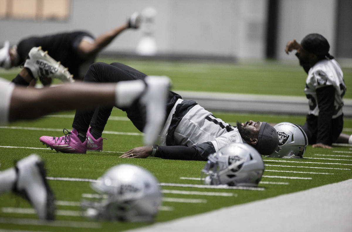 Raiders defensive back Trayvon Mullen (27) stretches during an NFL football training camp pract ...