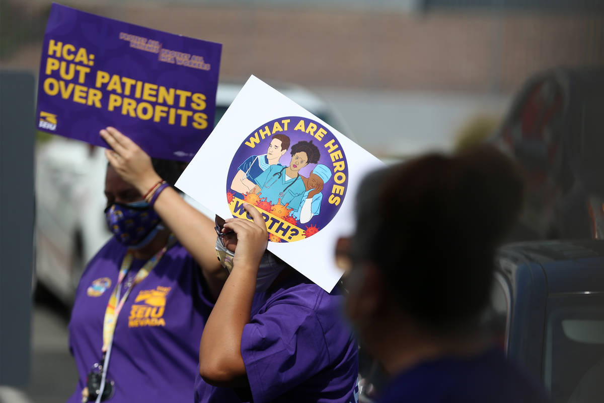 Health care workers with SEIU Local 1107 HCA stand outside of the Nevada Division of Public Hea ...