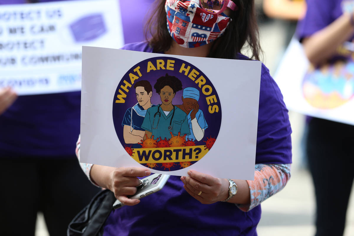 A SEIU Local 1107 HCA health care worker stands outside of the Nevada Division of Public Health ...
