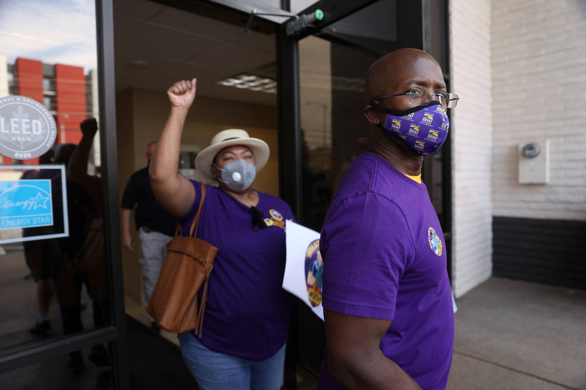 SEIU Local 1107 HCA health care workers Mike Forson, right, and Zabia Norman exit the building ...