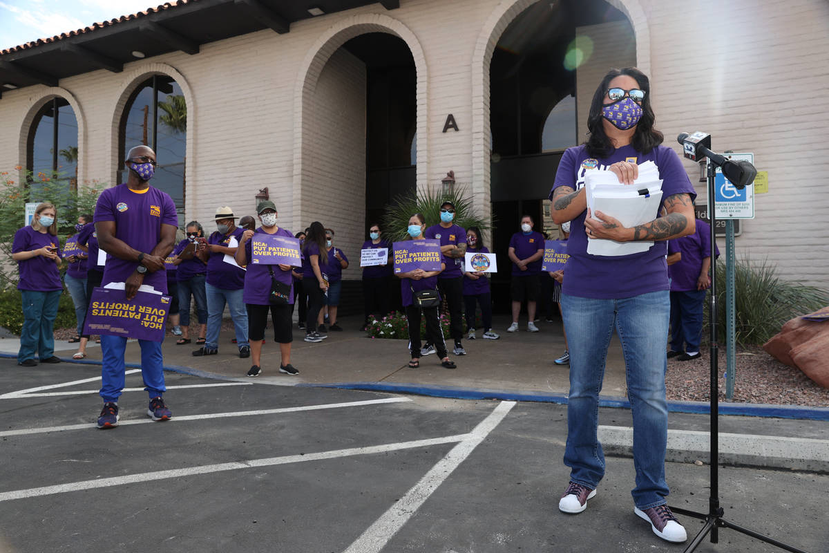 SEIU Local 1107 HCA healthcare worker Erika Watanabe speaks to the press while waiting to deliv ...