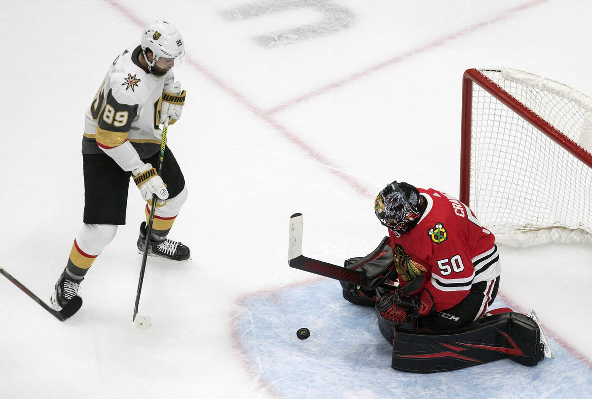 Vegas Golden Knights' Alex Tuch (89) is stopped by Chicago Blackhawks goalie Corey Crawford (50 ...