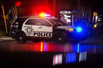 A group of Las Vegas Metro officers wait outside University Medical Center after an officer was ...