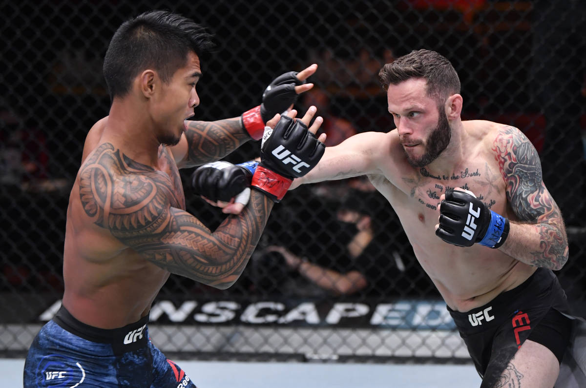 LAS VEGAS, NEVADA - AUGUST 15: (R-L) Tony Kelley punches Kai Kamaka in their featherweight bout ...
