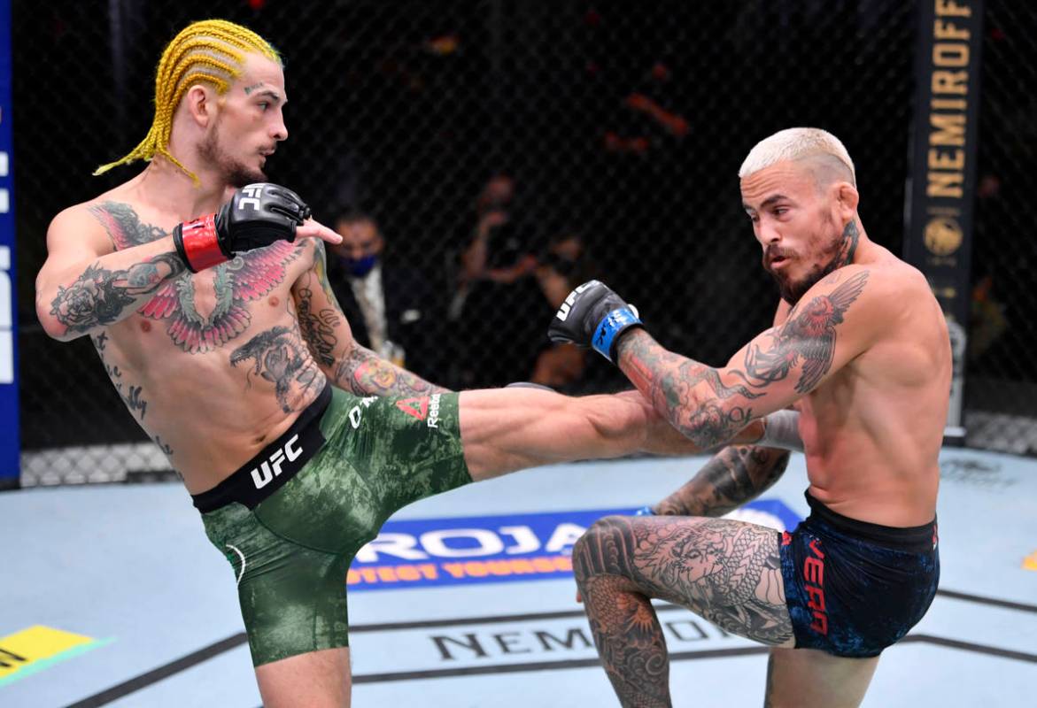 LAS VEGAS, NEVADA - AUGUST 15: (L-R) Sean O'Malley kicks Marlon Vera of Ecuador in their bantam ...