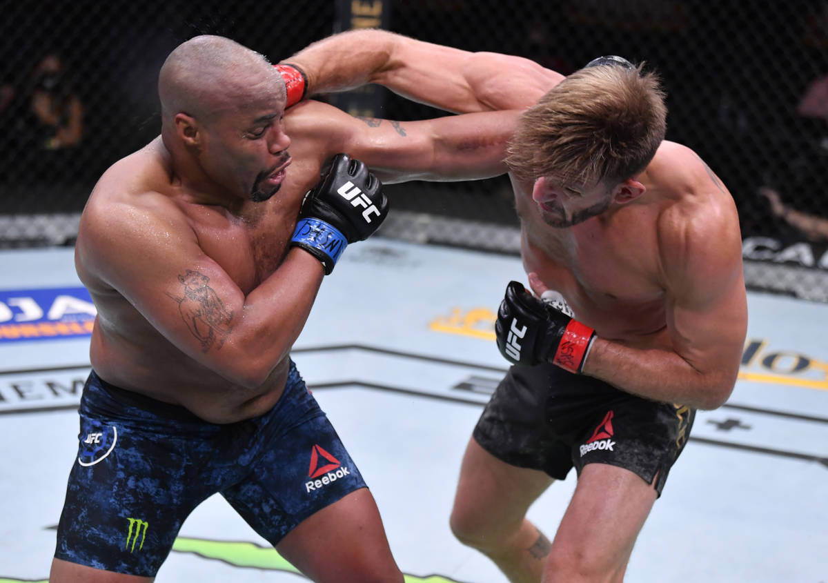 LAS VEGAS, NEVADA - AUGUST 15: (R-L) Stipe Miocic punches Daniel Cormier in their UFC heavyweig ...