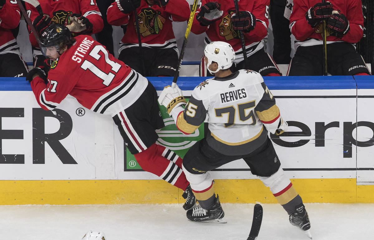 Vegas Golden Knights' Ryan Reaves (75) checks Chicago Blackhawks' Dylan Strome (17) during the ...