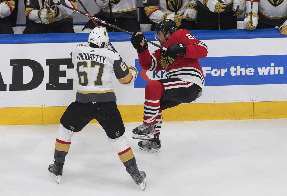 Vegas Golden Knights' Max Pacioretty (67) checks Chicago Blackhawks' Ryan Carpenter (22) during ...