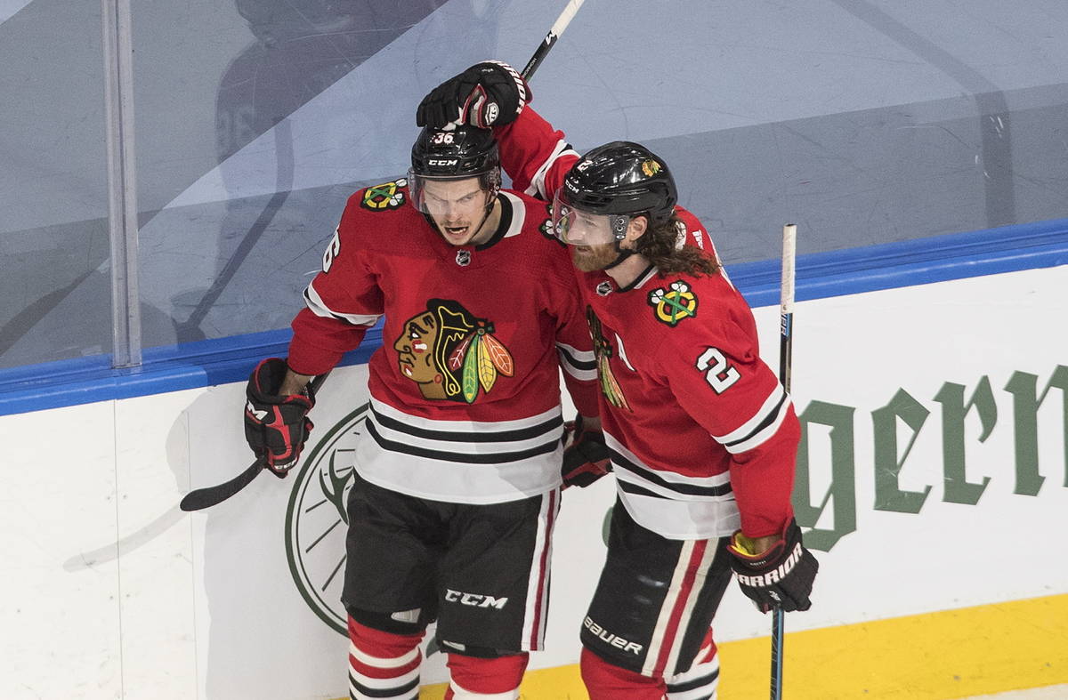 Chicago Blackhawks' Matthew Highmore (36) and Duncan Keith (2) celebrate a goal during first-pe ...