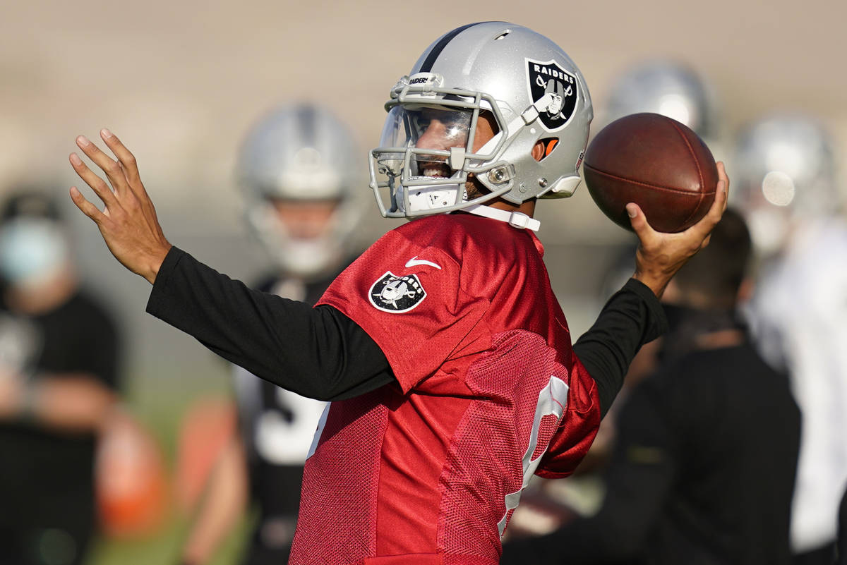 Las Vegas Raiders quarterback Marcus Mariota throws during an NFL football training camp practi ...