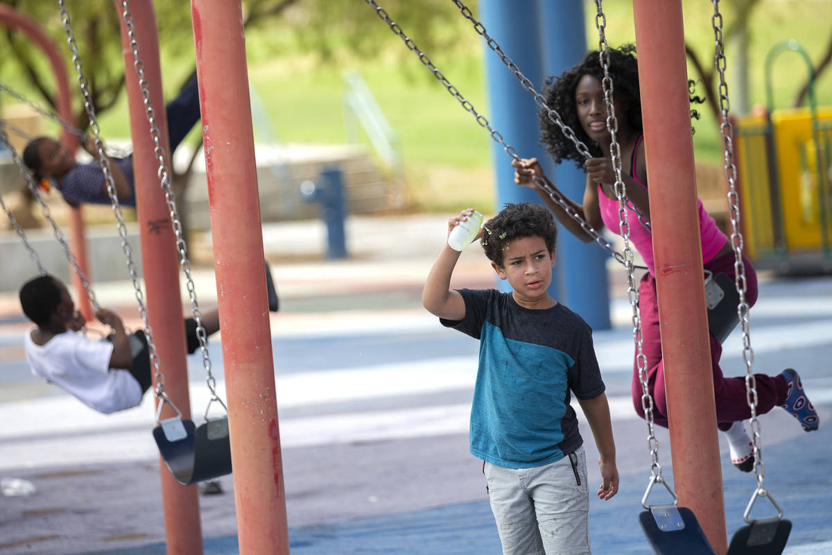 Wyatt Reed, 7, second from right, pours juice on his head to cool off after her family particip ...