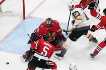 Vegas Golden Knights' Nicolas Roy (10) is stopped by Chicago Blackhawks goalie Corey Crawford ( ...