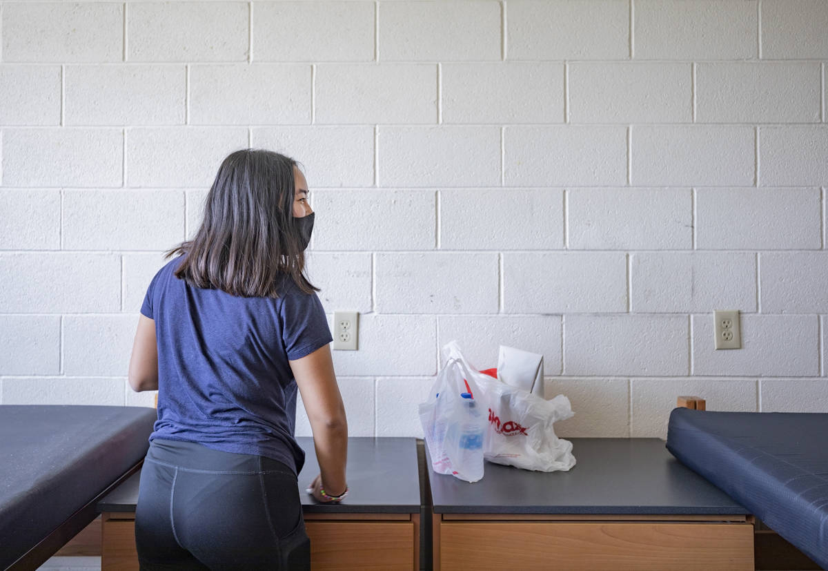 UNLV freshman Lia Cheung, 18, of Miami, sanitizes her furniture in her dorm at Dayton Hall, in ...