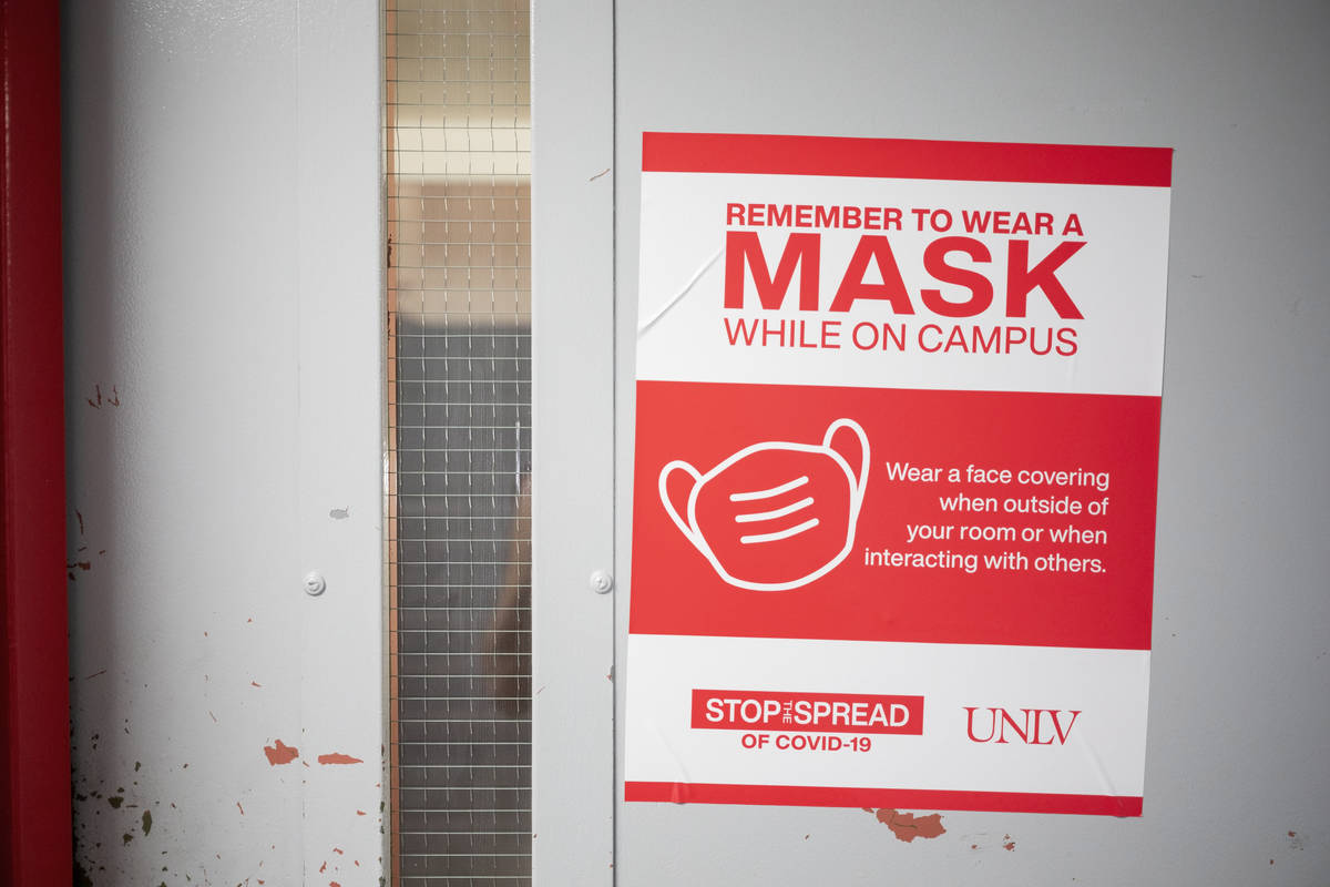 A sign requiring masks is seen around Dayton Hall at UNLV in Las Vegas on Monday, Aug. 17, 202 ...