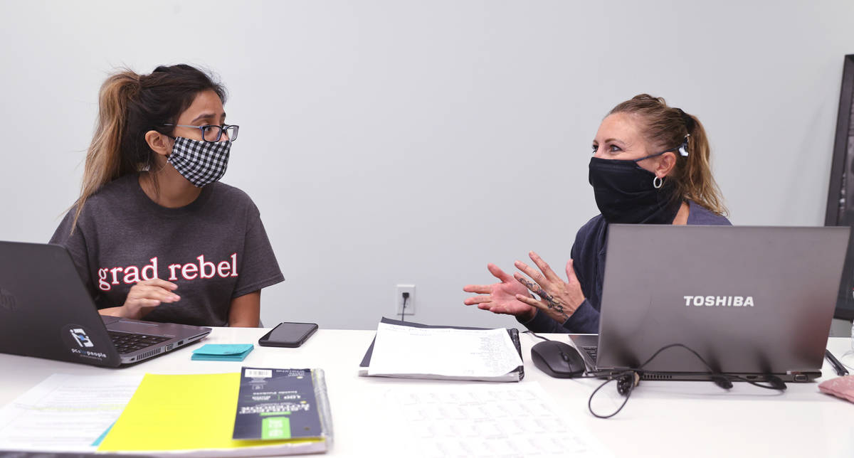 Jenn Bowers, senior disease investigator with Southern Nevada Health District, right, works on ...