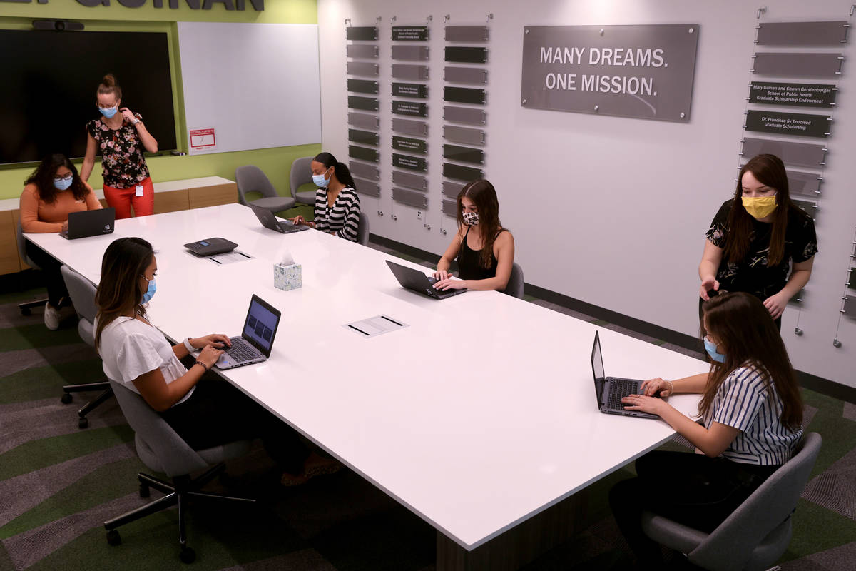 Master's student Kristina Mihajlovski, standing left, and Ph.D. student Casey Barber, standing ...