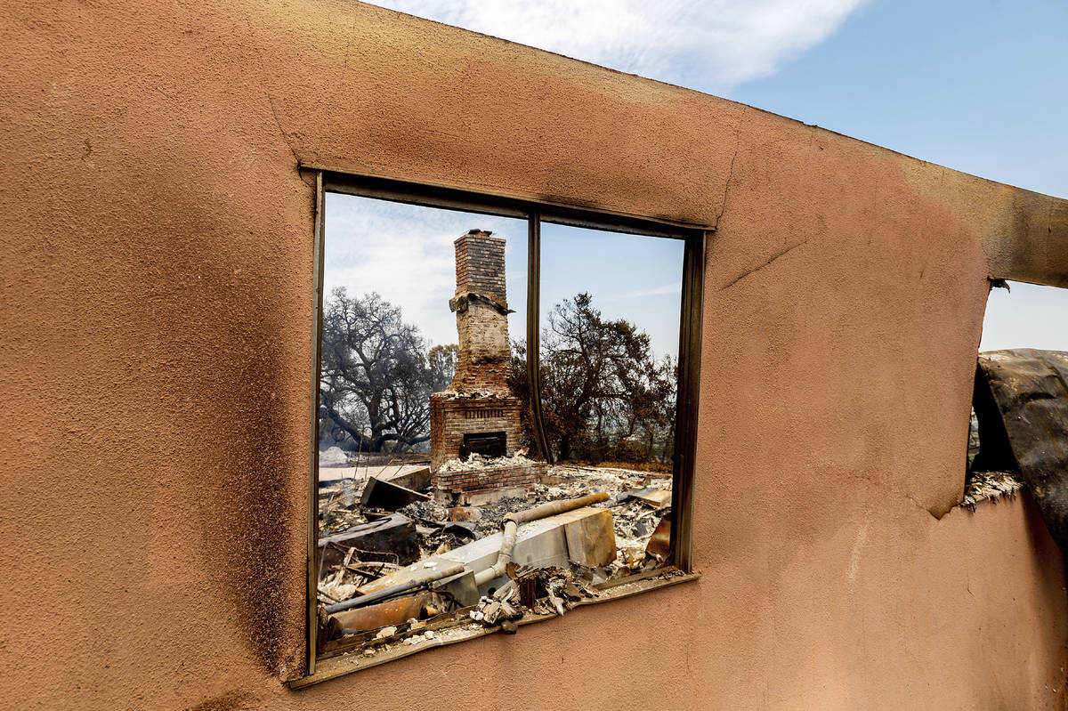 A chimney stands at a home destroyed by the River Fire in Salinas, Calif., on Monday, Aug. 17, ...