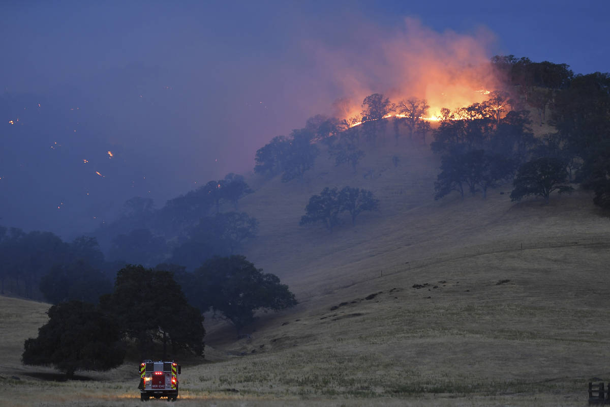Spot fires burn on a hillside caused by a lightning strike along Marsh Creek Road in Brentwood, ...