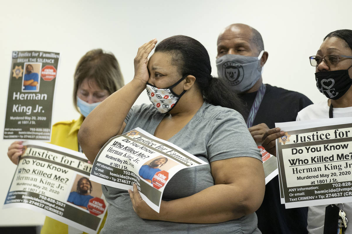 Hermanda Taylor, middle, wipes tears from her eyes during a press briefing on Tuesday, Aug. 18 ...