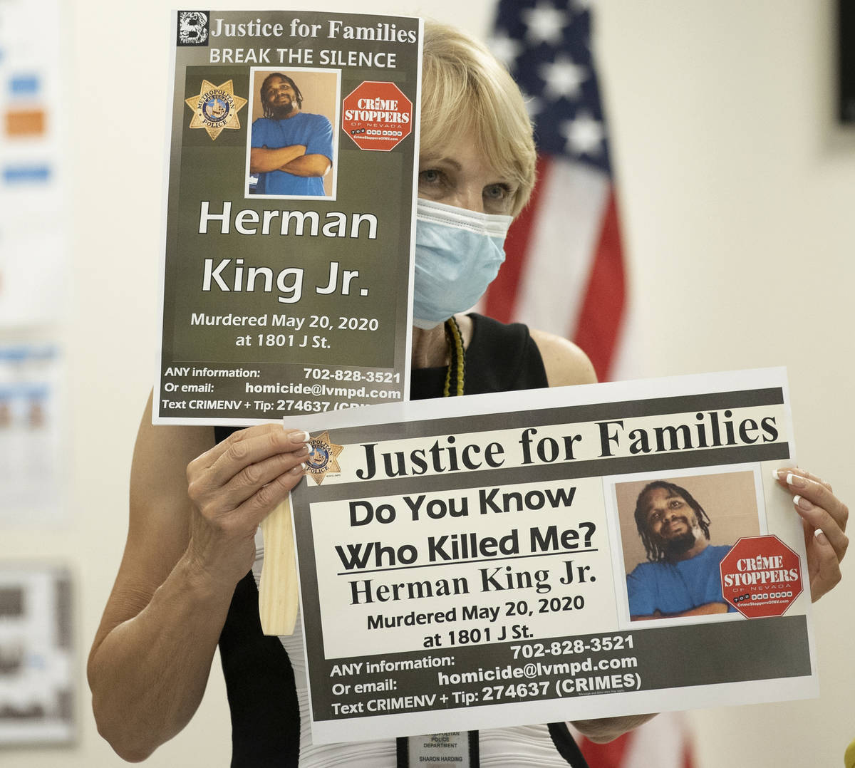 Metropolitan Police Department volunteer manager Sharon Harding holds signs during a press brie ...