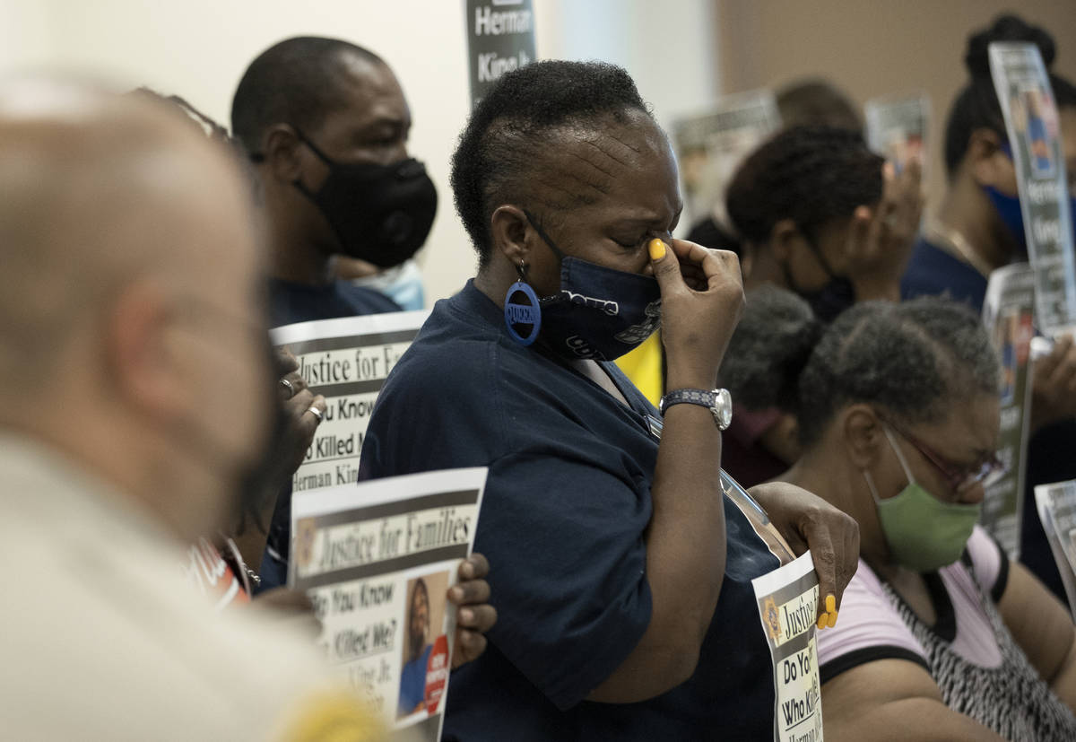 Nisha Taylor, middle, wipes tears from her eyes during a press briefing with Las Vegas police o ...