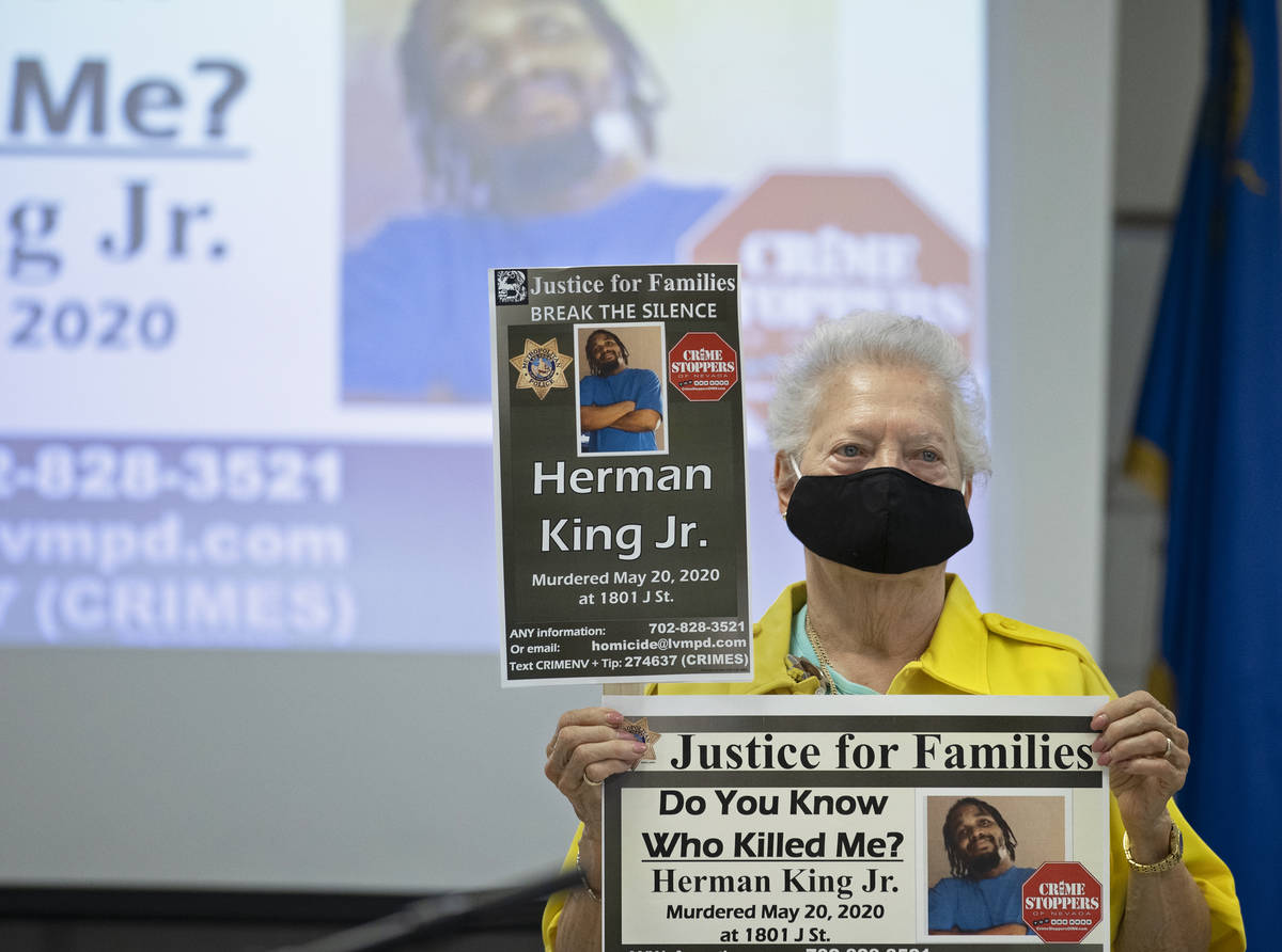 Metro volunteer Linda Vish holds signs during a press briefing on Tuesday, Aug. 18, 2020, in La ...