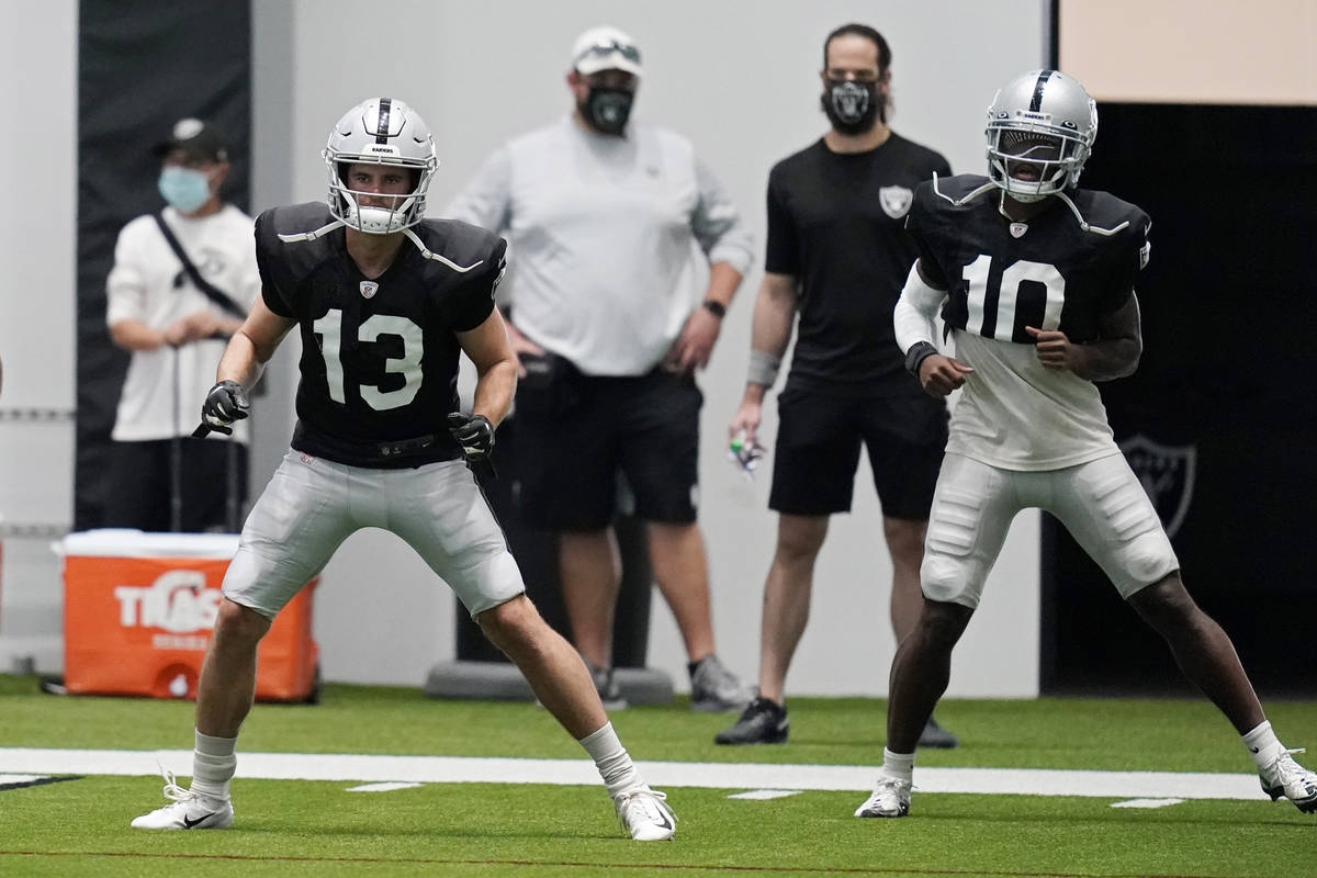 Las Vegas Raiders wide receiver Hunter Renfrow (13) and wide receiver Rico Gafford (10) warm up ...