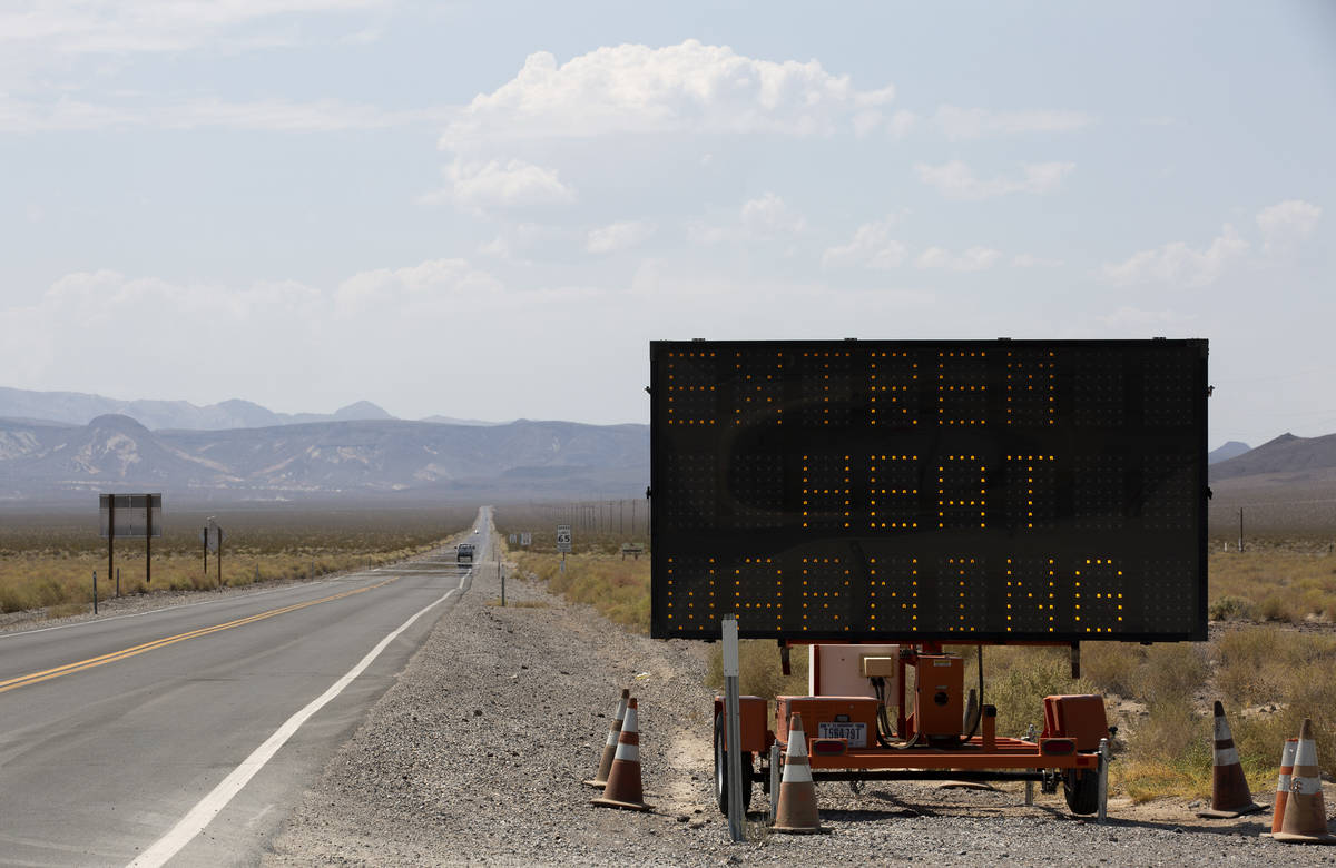 The road into Death Valley National Park features a sign warning of excessive heat on Monday, A ...
