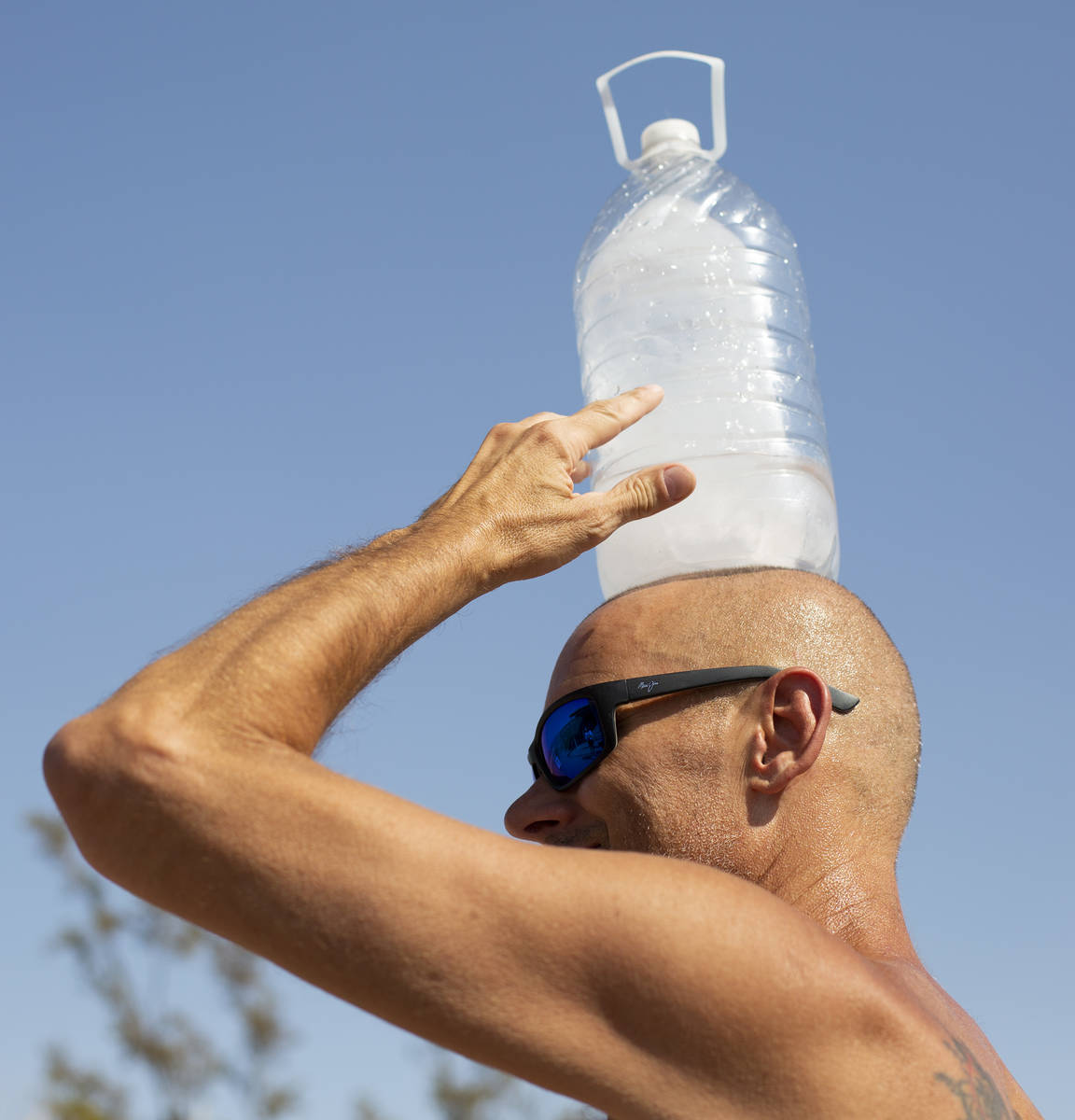 Steve Krofchik of Las Vegas holds ice on his head outside Furnace Creek Visitor Center at Death ...