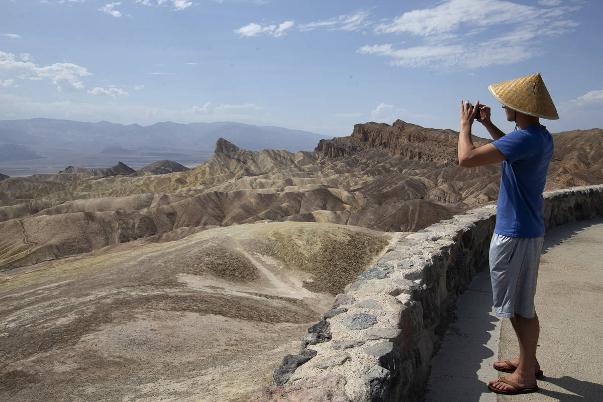 Peter Vukasin snaps a photo at Zabriskie Point in Death Valley National Park in California as t ...