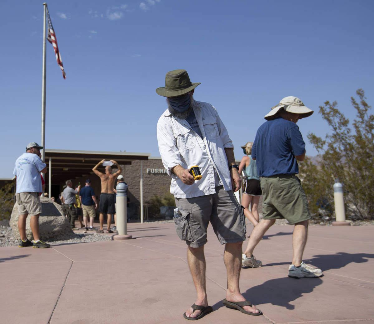 Mark Lehman, data manager at Mojave Desert Network, takes the temperature of the ground outside ...