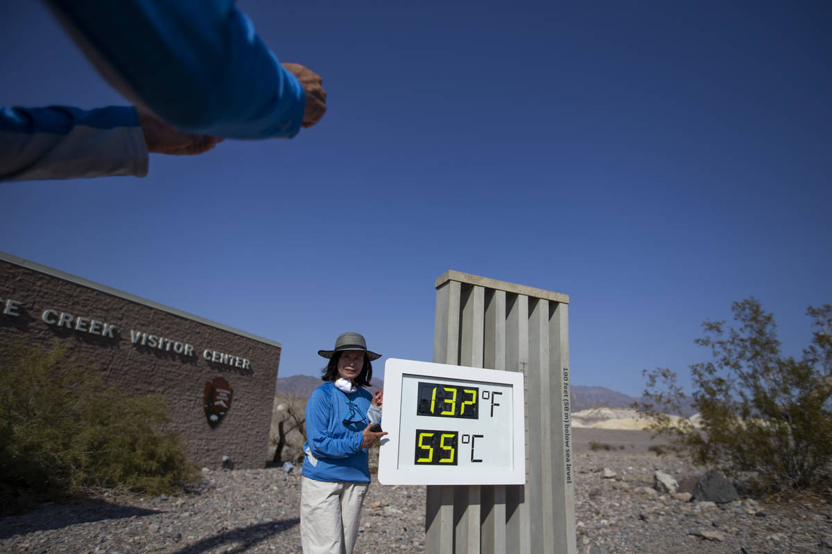 Margie Owen poses for a photo beside the thermometer outside Furnace Creek Visitor Center in De ...