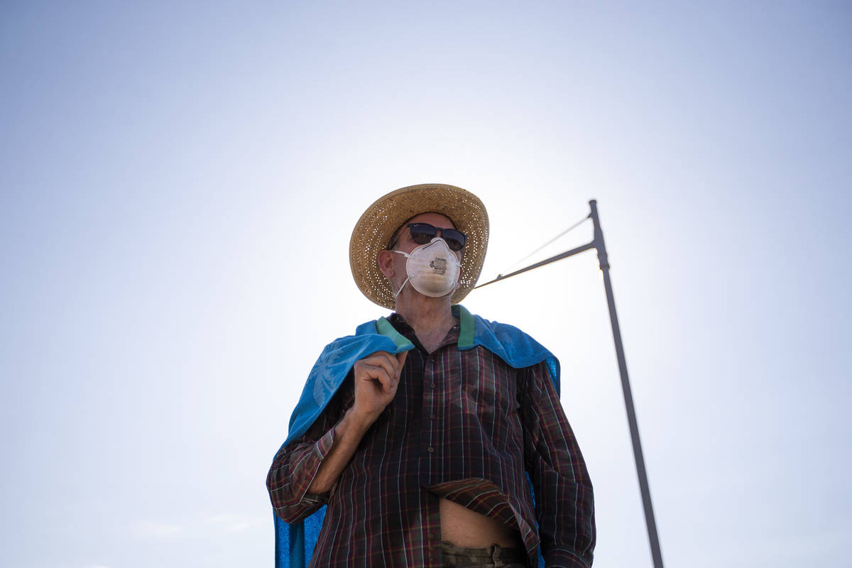 John Grattes of Whitter, California, watches as people take photos in front of the thermometer ...