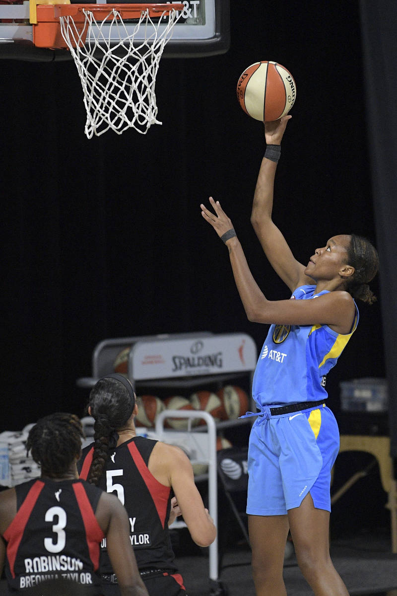 Chicago Sky forward Azura Stevens, right, puts up a shot in front of Las Vegas Aces forward Dea ...