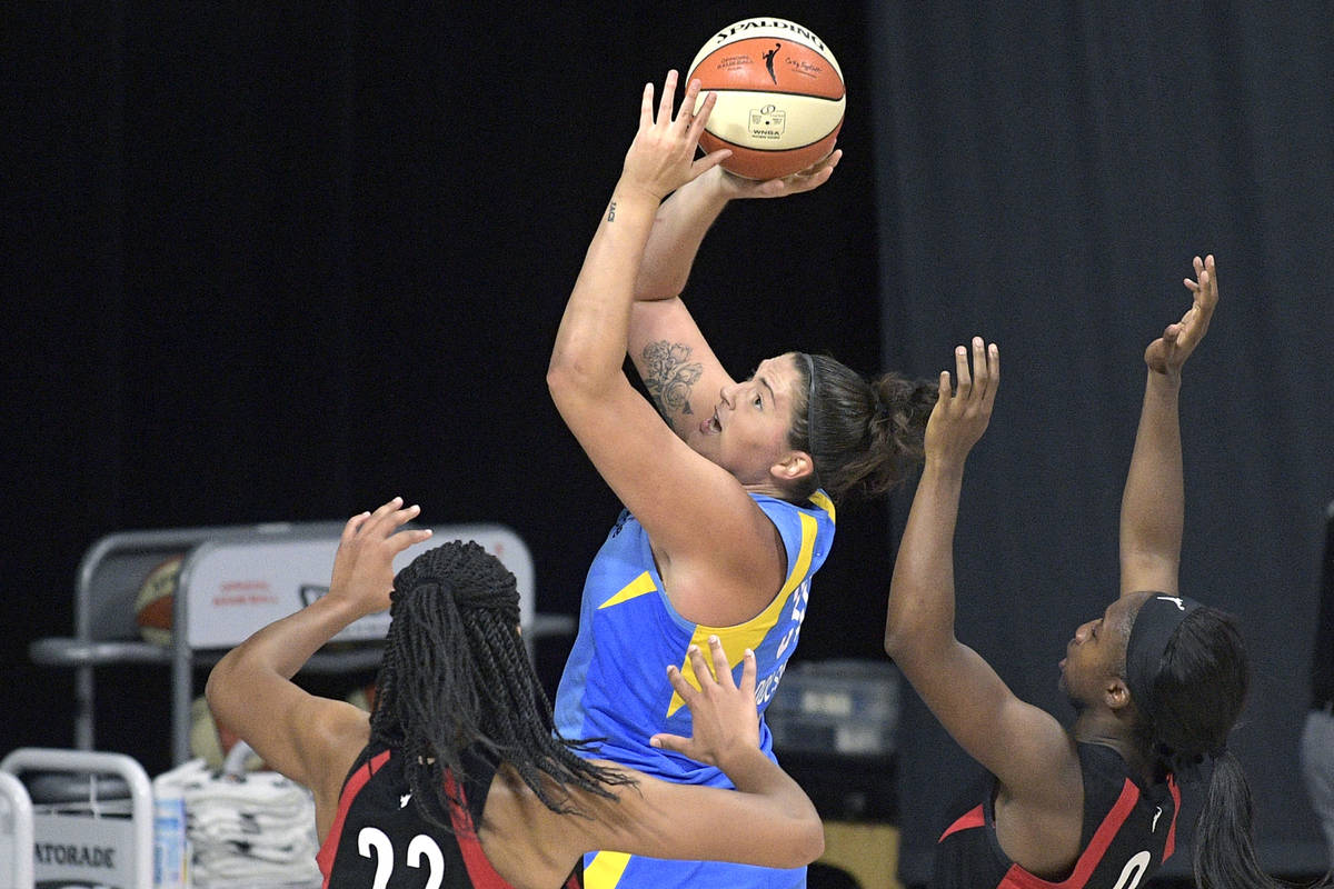 Chicago Sky center Stefanie Dolson goes up for a shot between Las Vegas Aces center A'ja Wilson ...