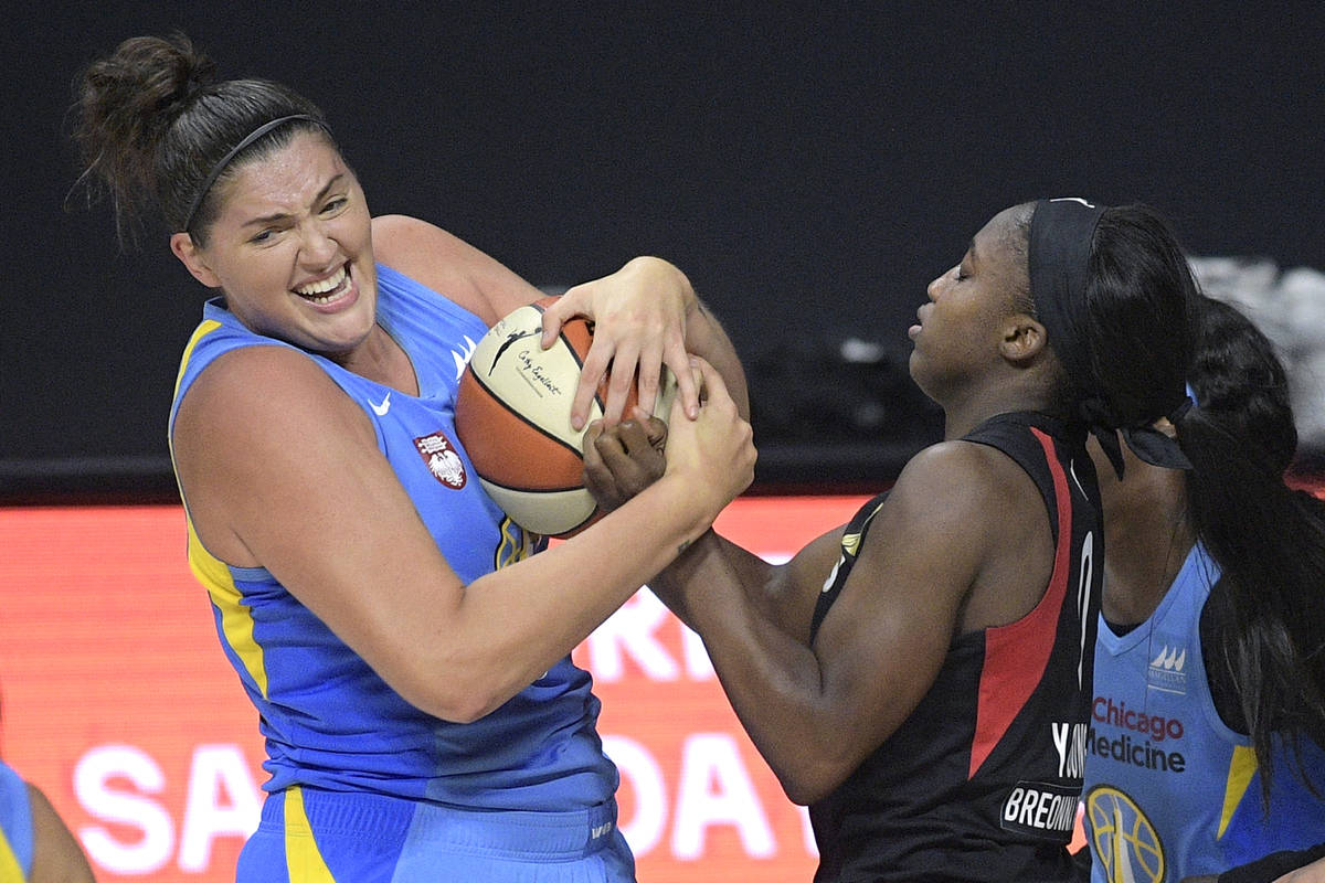 Chicago Sky center Stefanie Dolson, left, gains control of a rebound with Las Vegas Aces guard ...